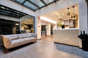 a living room with a couch and a counter at Hotel Lux Santiago in Santiago de Compostela