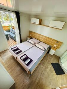 a bedroom with a bed and a large window at Family Home Claudia in Makarska