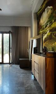 a hotel room with a large painting on the wall at Marios House in Kini