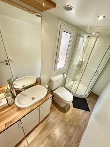 a bathroom with a sink and a toilet and a shower at Family Home Claudia in Makarska