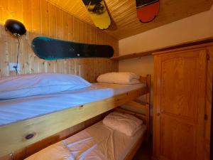 a bedroom with two bunk beds in a boat at Homency - Résidence les Chanses E3 in L'Alpe-d'Huez