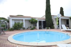a swimming pool in front of a house at Chambre privée indépendante, piscine in Cap d'Agde