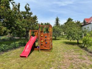 a playground with a red slide in a yard at Zahradní 6 in Velké Pavlovice