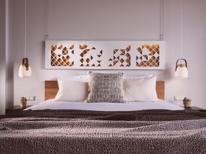 a bedroom with a large bed with white pillows at Hotel St.John Suites Adults Only in Tsilivi +37 photos
