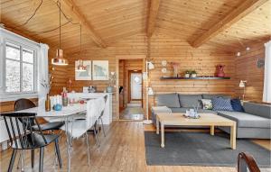 a living room with a couch and a table at Nice Home In Knebel With Kitchen in Knebel
