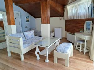 a living room with a couch and a table at Villa Zelenika in Sinemorets