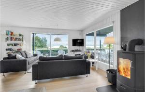 a living room with a couch and a fireplace at Amazing Home In Roslev With Wifi in Roslev
