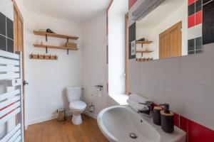 a bathroom with a white sink and a toilet at Cabana & L'Auberge Beaujolaise - Maison de Ville in Ouroux +29 photos