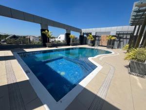 a swimming pool on the roof of a building at D' Elmer's Place Hotel in Tuguegarao City