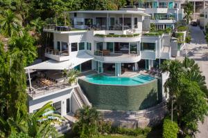 an aerial view of a house with a swimming pool at Villa Beyond-Namaste 16 Bedroom Fully Staffed Seaview Villa in Ban Thalat Choeng Thale