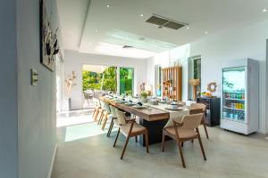 a large dining room with a long table and chairs at Villa Beyond-Namaste 16 Bedroom Fully Staffed Seaview Villa in Ban Thalat Choeng Thale