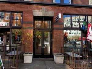 a brick building with a revolving door on a street at Ace Hotel Seattle in Seattle