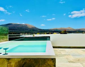 a swimming pool on the roof of a house at Canaryislandshost I Viñedos in Uga