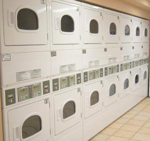 a row of white washing machines in a laundrette at Hotel Laurier - Apartment Style Residence in Waterloo