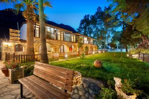 a wooden bench sitting in front of a building at Alados Otel in Turgut