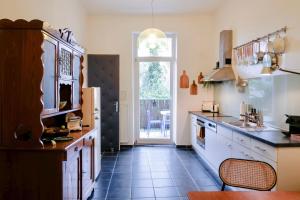 a kitchen with a sink and a counter top at Kunstvolles Apartment im Zentrum mit Balkon und Parkplatz in Graz