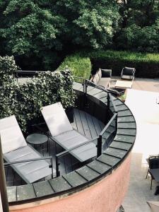 a patio with a table and chairs on around table at Hotel-Restaurant Beim Schlass in Wiltz +40 photos