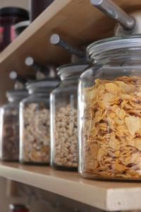 a row of glass jars filled with nuts on a shelf at Altes Pastorat in Barmstedt