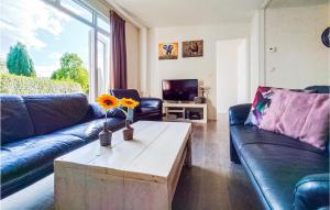 a living room with a couch and a coffee table at 4 Bedroom Cozy Home In Heinkenszand in Heinkensand