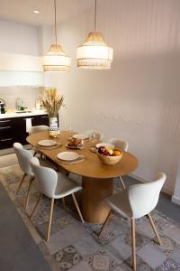 a dining room table with chairs and a bowl of fruit on it at Casas349h Alicante City Centre Trafalgar in Alicante +30 photos