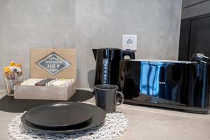 a counter with a coffee maker and a plate on a table at Hostel Dos Estaciones - Albergue Juvenil - FREE towels, coffee & tea, remote check-in in Alicante