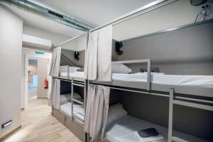 a group of bunk beds in a room at Hostel Dos Estaciones - Albergue Juvenil - FREE towels, coffee & tea, remote check-in in Alicante