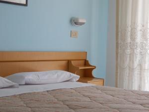 Postel nebo postele na pokoji v ubytování Hotel Vittoria