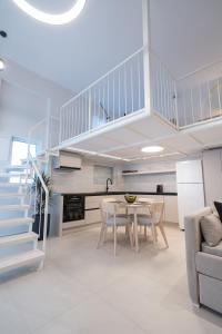 a living room with a table and a staircase at June Home in Platanes