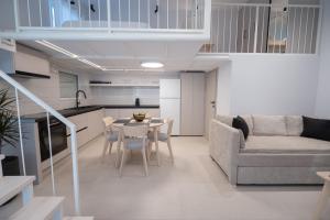 a kitchen and a living room with a table and a couch at June Home in Platanes +10 photos