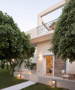 a house with a balcony and a tree at June Home in Platanes