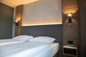 Postel nebo postele na pokoji v ubytování Roomingtons Karoli Waldkirchen