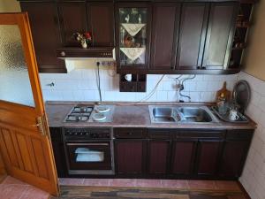 a kitchen with a sink and a stove at Stefin kutak HOME in Bosanski Novi
