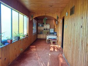 a hallway of a house with a table and windows at Stefin kutak HOME in Bosanski Novi