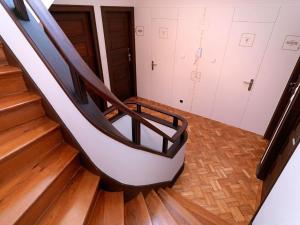 a set of stairs in a room with wooden floors at Uporto House Villa in Porto