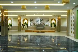 a lobby with a couch in the middle of a building at The Gamora in Gwalior