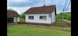 a white house with a fence in a yard at Stefin kutak HOME in Bosanski Novi +6 photos
