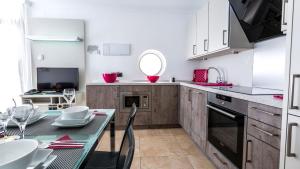 a kitchen with a table and a dining room at Bahia Blanca in Puerto Rico de Gran Canaria