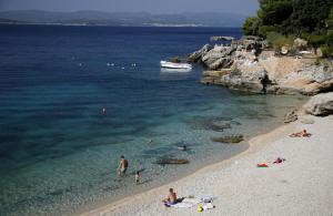 a group of people on a beach near the water at GLamping tents Adriatic - Orebic in Orebić