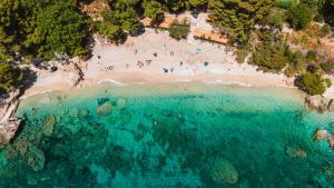 an aerial view of a beach with people on it at GLamping tents Adriatic - Orebic in Orebić