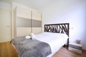 ein Schlafzimmer mit einem großen Bett mit weißer Bettwäsche in der Unterkunft Apartamento con terraza en San Vicente in O Grove