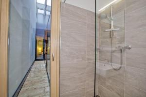 a bathroom with a shower with a glass door at Residenz Wildkogelbahnen Top 6 in Neukirchen am Großvenediger +28 photos