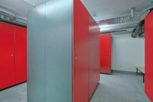 a row of red lockers in a room at Residenz Wildkogelbahnen Top 6 in Neukirchen am Großvenediger