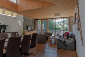 a living room with a table and chairs and a dining room at Residenz Wildkogelbahnen Top 12 in Neukirchen am Großvenediger