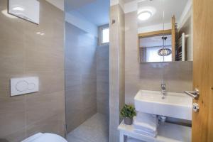 a bathroom with a sink and a toilet and a mirror at Residenz Wildkogelbahnen Top 16 in Neukirchen am Großvenediger +28 photos