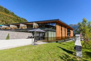 a large building with a grass field in front of it at Residenz Wildkogelbahnen Top 18 in Neukirchen am Großvenediger