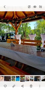 a table in a pavilion with cars in a parking lot at Apartmani Neven in Irig