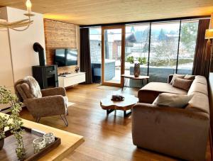 a living room with a couch and a table at Residenz Wildkogelbahnen Top 17 in Neukirchen am Großvenediger