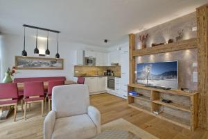 a living room with a kitchen and a dining room at Residenz Wildkogelbahnen Top 19 in Neukirchen am Großvenediger +19 photos