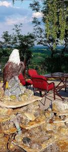 a statue of a bear sitting next to a chair at Apartmani Neven in Irig