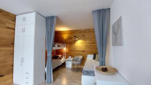 a bedroom with a bunk bed and a desk in a room at Apartmán REZE Šumava in Železná Ruda +72 photos